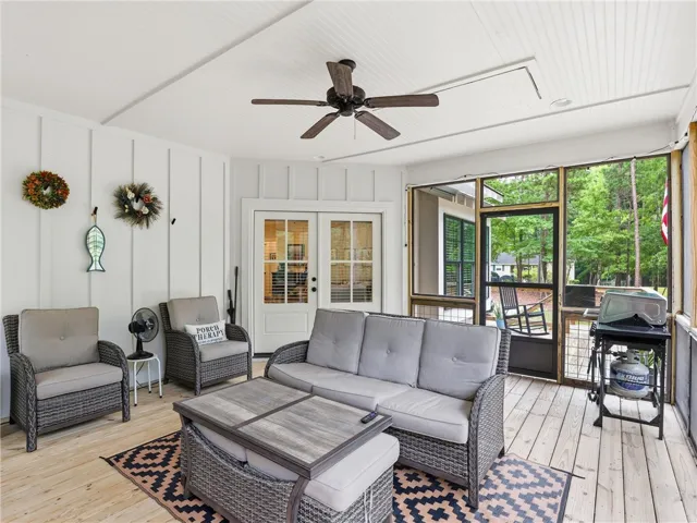 Enjoy outdoor living on this inviting screened porch, perfect for relaxation and gatherings.
