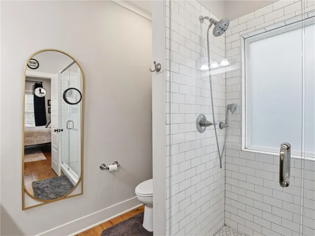 Refined bathroom with a large shower featuring subway tile and a sleek glass enclosure.