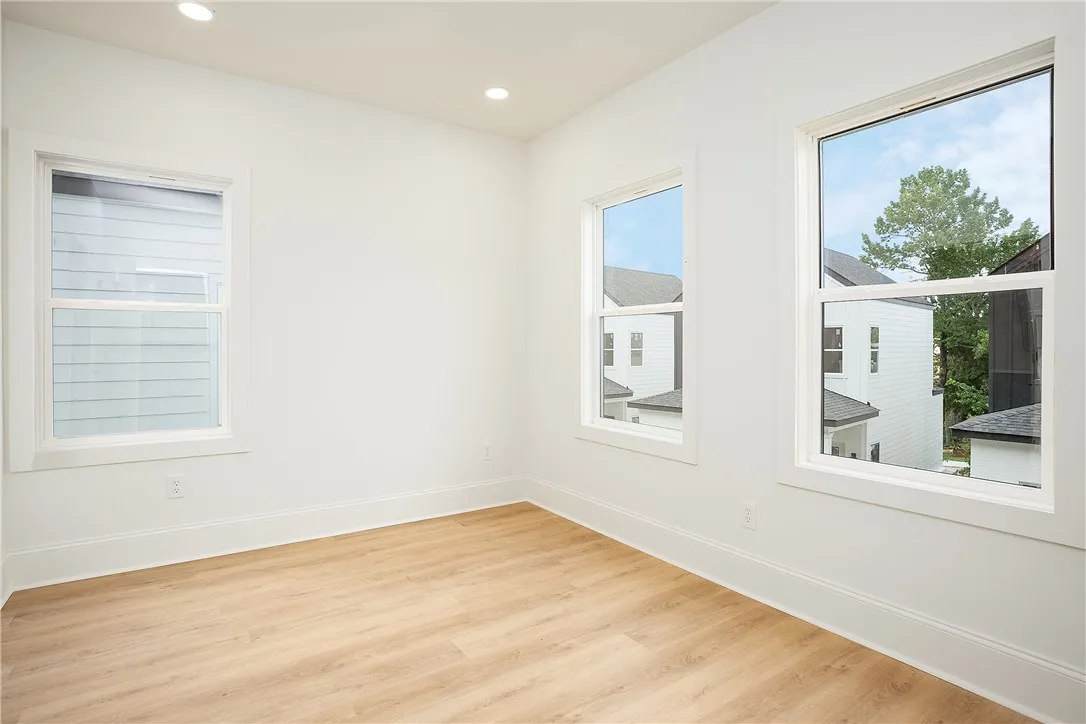 Natural light pours into this room, illuminating the light-toned hardwood flooring.