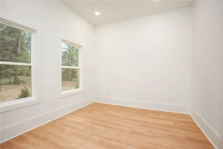 Bright windows and warm wood flooring enhance this versatile space.