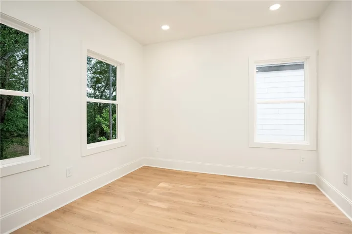 Naturally illuminated, this well-proportioned room features modern recessed lighting and durable hardwood-style flooring.