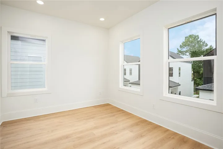 Natural light pours into this room, illuminating the light-toned hardwood flooring.