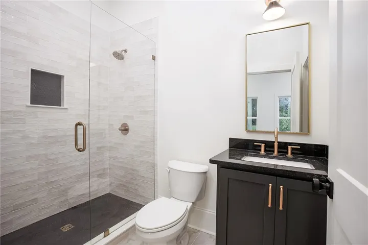 A well-appointed bathroom with a spacious glass-enclosed shower and modern vanity.