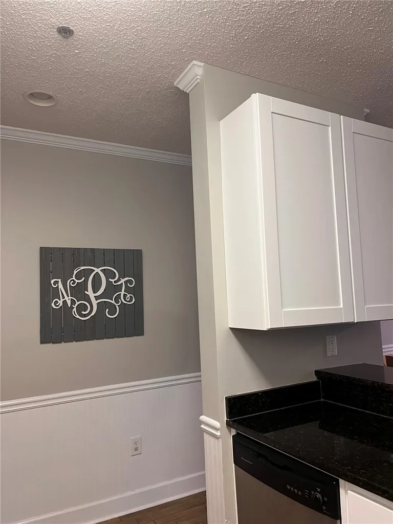 Refined interior featuring sophisticated wainscoting and crown molding throughout.