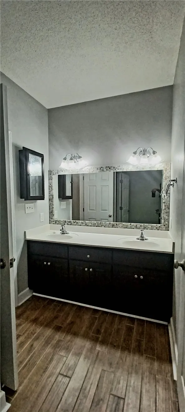 Double vanity with ample counter space and a large mirror anchors this functional bathroom.