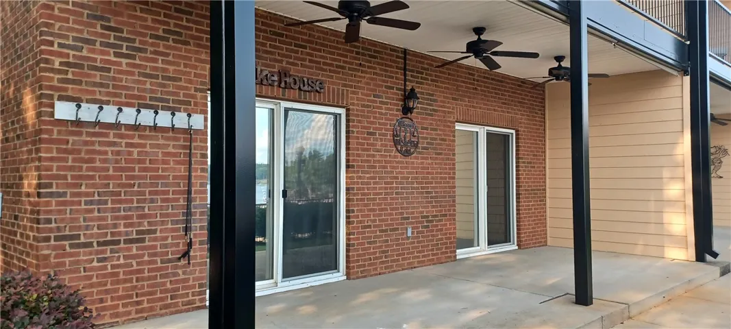 An inviting covered patio featuring brick and siding, perfect for outdoor relaxation.