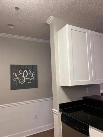Refined interior featuring sophisticated wainscoting and crown molding throughout.