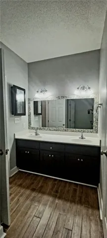 Double vanity with ample counter space and a large mirror anchors this functional bathroom.