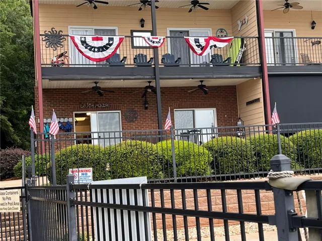 Two levels of private balconies create inviting outdoor living spaces on this charming brick and siding dwelling.