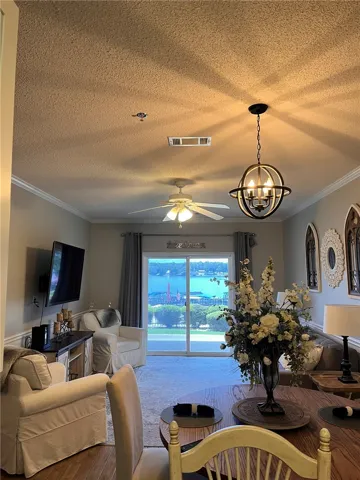 Sliding glass doors open to a serene lake view from this inviting living area.