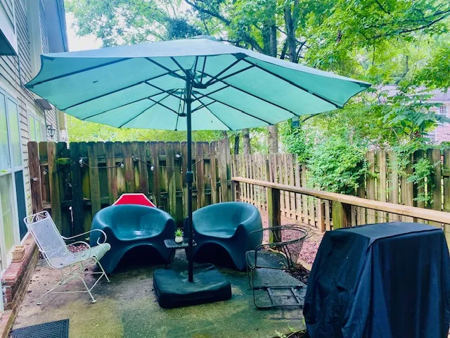 A private outdoor patio retreat, perfect for unwinding amidst lush greenery.