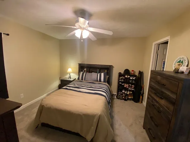 A comfortable bedroom with soft lighting and cozy carpeting awaits.