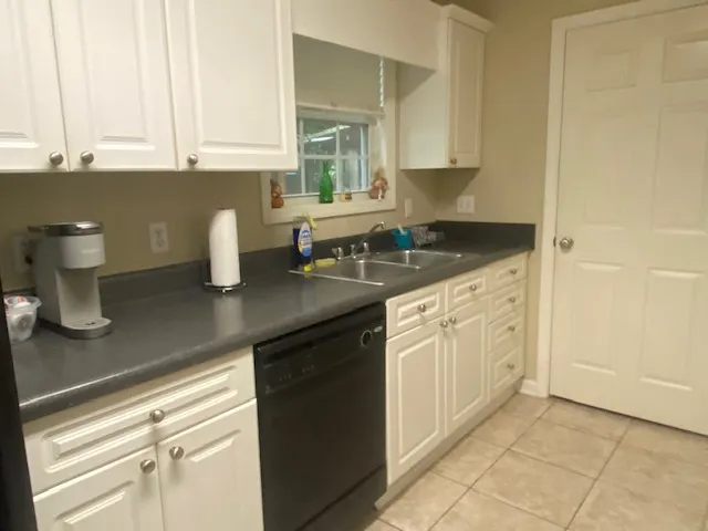 A well-lit kitchen features functional appliances and ample counter space for daily use.
