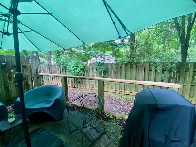 A secluded patio retreat offers a serene escape, surrounded by nature's tranquility.