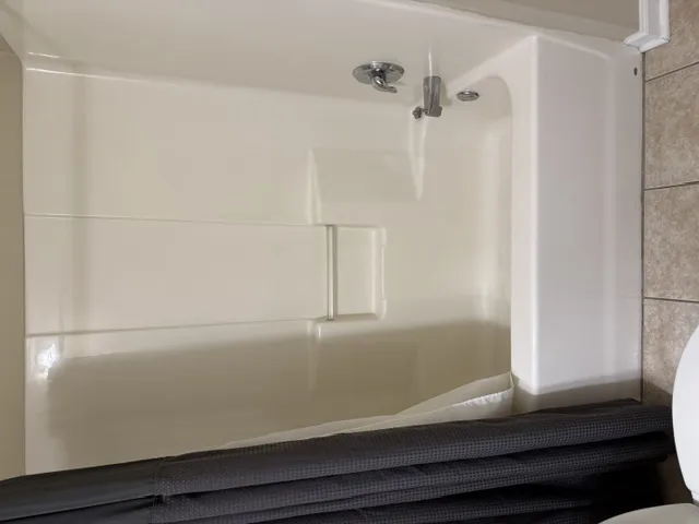 A well-maintained shower and tub combination awaits for daily refreshment.