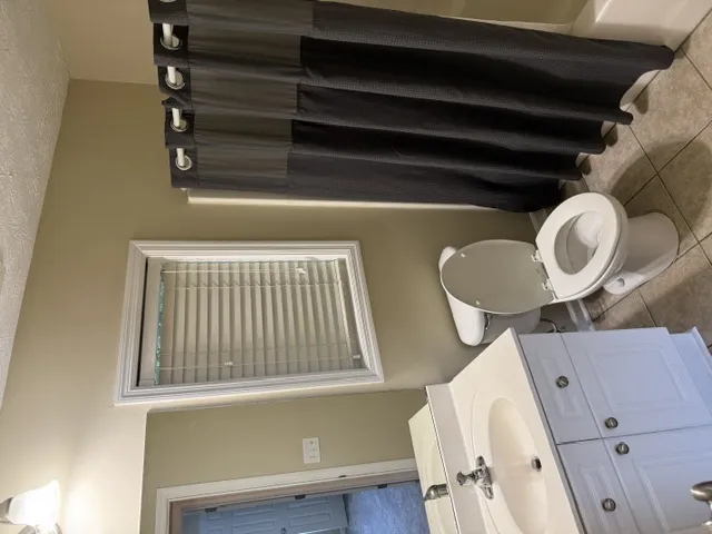 Functional full bathroom with neutral tones and essential fixtures for comfortable living.