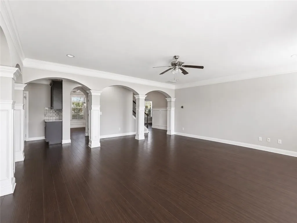 Architectural arches and rich hardwood flooring create an inviting, flowing living space.