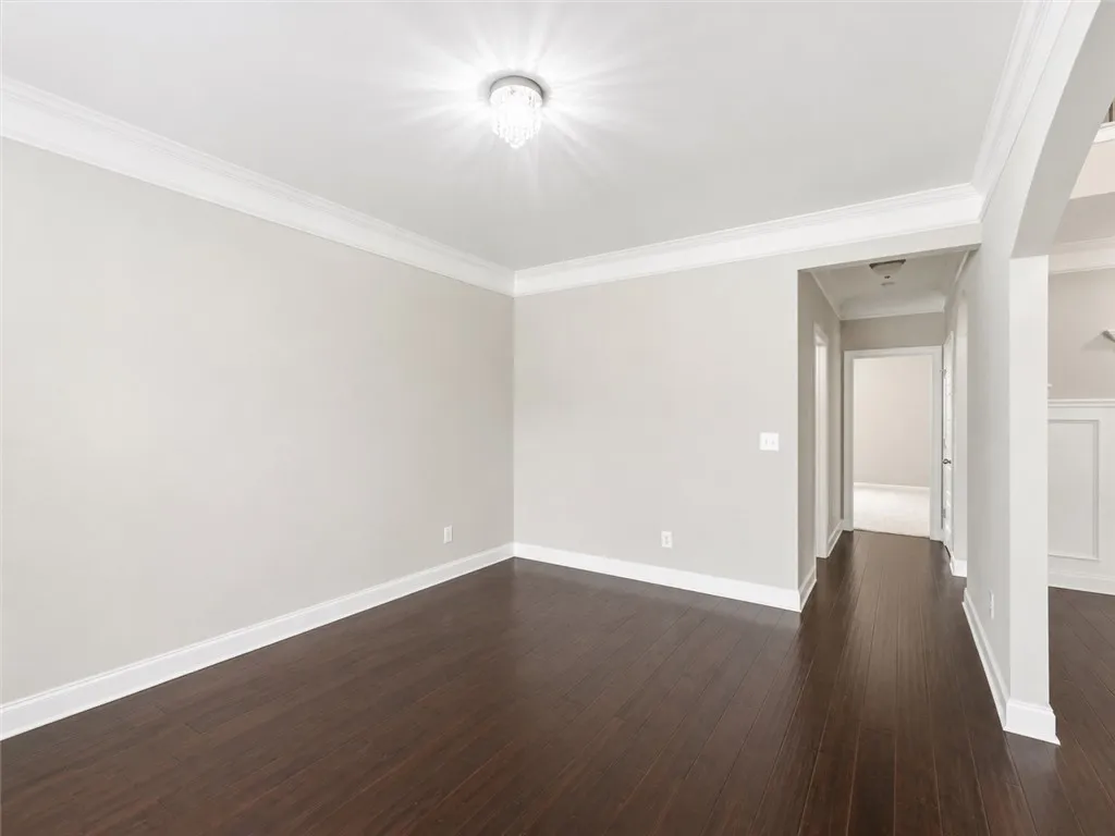 Rich hardwood floors complement elegant crown molding throughout this inviting space.