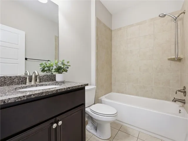 1st flr - Full Bathroom Elegant dark cabinetry and granite counters define this well-appointed bathroom space.