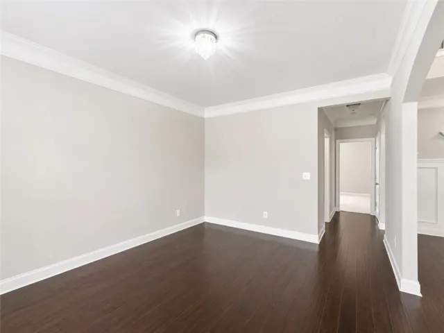 Rich hardwood floors complement elegant crown molding throughout this inviting space.
