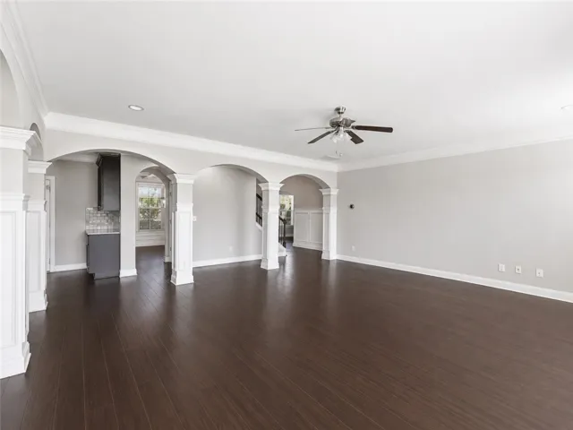 Architectural arches and rich hardwood flooring create an inviting, flowing living space.