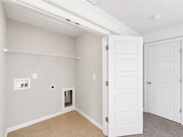 A well-appointed laundry room features a wire shelf and tile flooring.