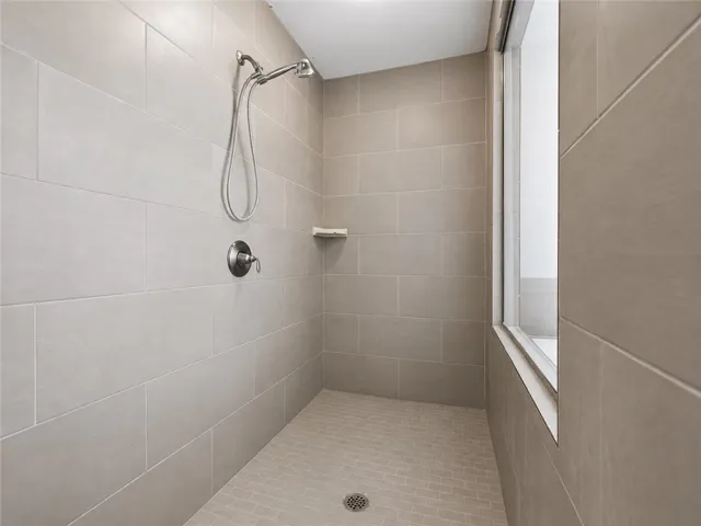 A well-appointed shower stall features modern tile work and sleek fixtures.