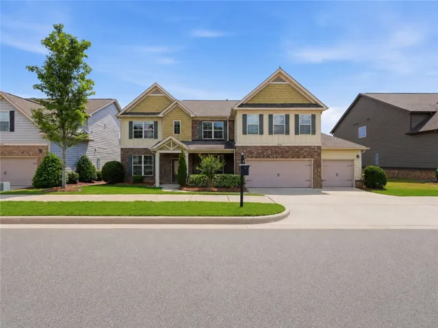 A well-maintained suburban residence presents a charming curb appeal with a blend of brick and siding.