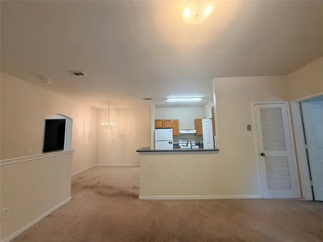 An inviting open-concept layout unites the living spaces, featuring a well-appointed kitchen and dedicated dining area.