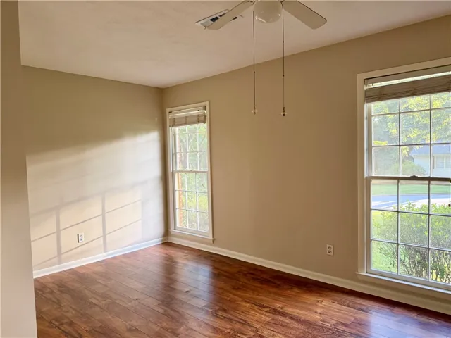 Large windows stretching across the front of the home invite natural light to fill the living spaces throughout the day.