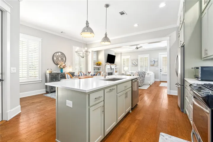 A well-appointed kitchen island offers generous counter space and a seamless flow to the inviting dining and living areas.