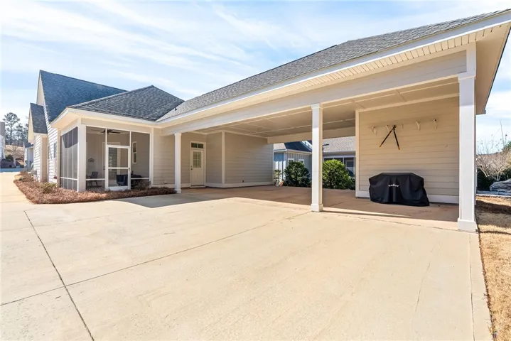 A screened porch and covered parking offer versatile outdoor living and utility space.