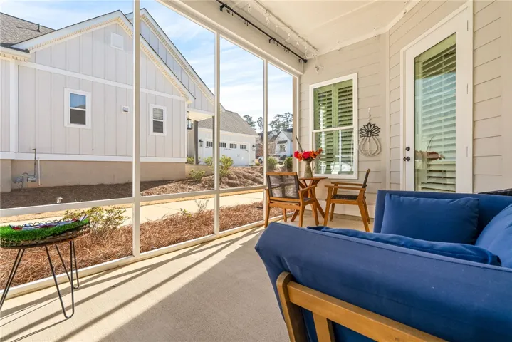 Relax and unwind on this inviting screened porch, offering serene views of the surrounding neighborhood.