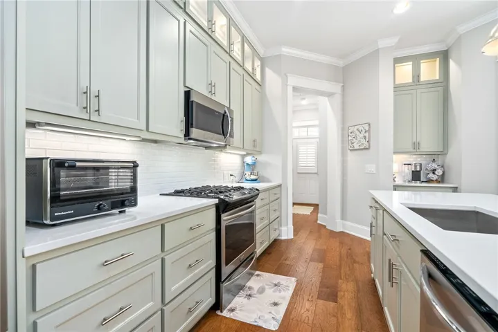 Culinary delights await in this bright kitchen with rich hardwood floors and premium appliances.