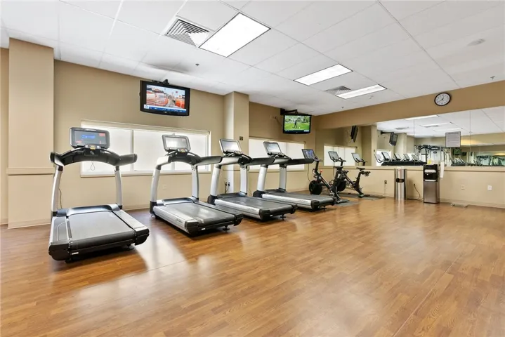 Maintain your fitness routine with ease in this well-equipped exercise room featuring ample space for various workouts.