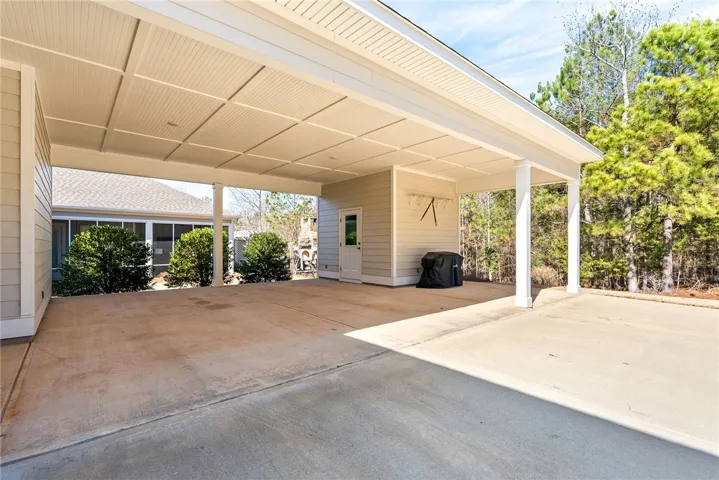 A spacious carport offers convenient parking with additional outdoor storage space.