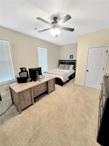 A versatile room combines productive workspace with a comfortable sleeping area, offering both function and repose.