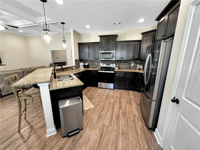A well-appointed culinary space featuring granite counters and durable flooring.