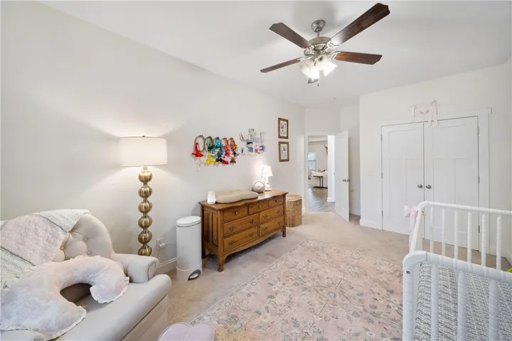Nursery features a ceiling fan for comfort and convenient closet storage.