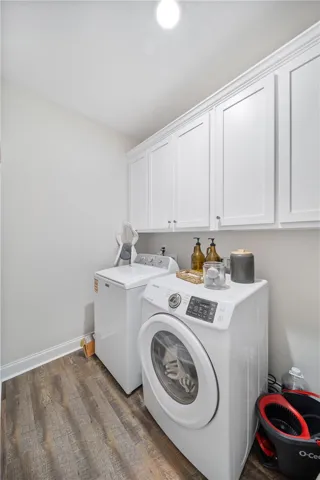 Ample cabinetry provides essential storage within this well-appointed laundry space.