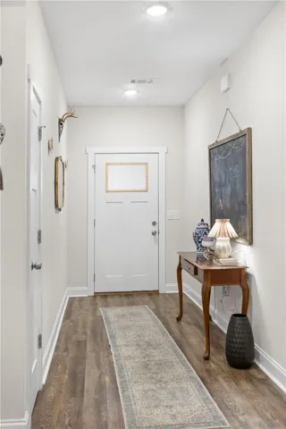 A welcoming entry hall with rich wood flooring invites you into this charming residence.