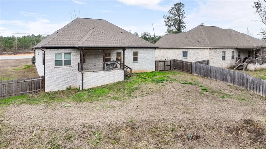 A spacious backyard with two homes offers privacy and ample outdoor living possibilities.