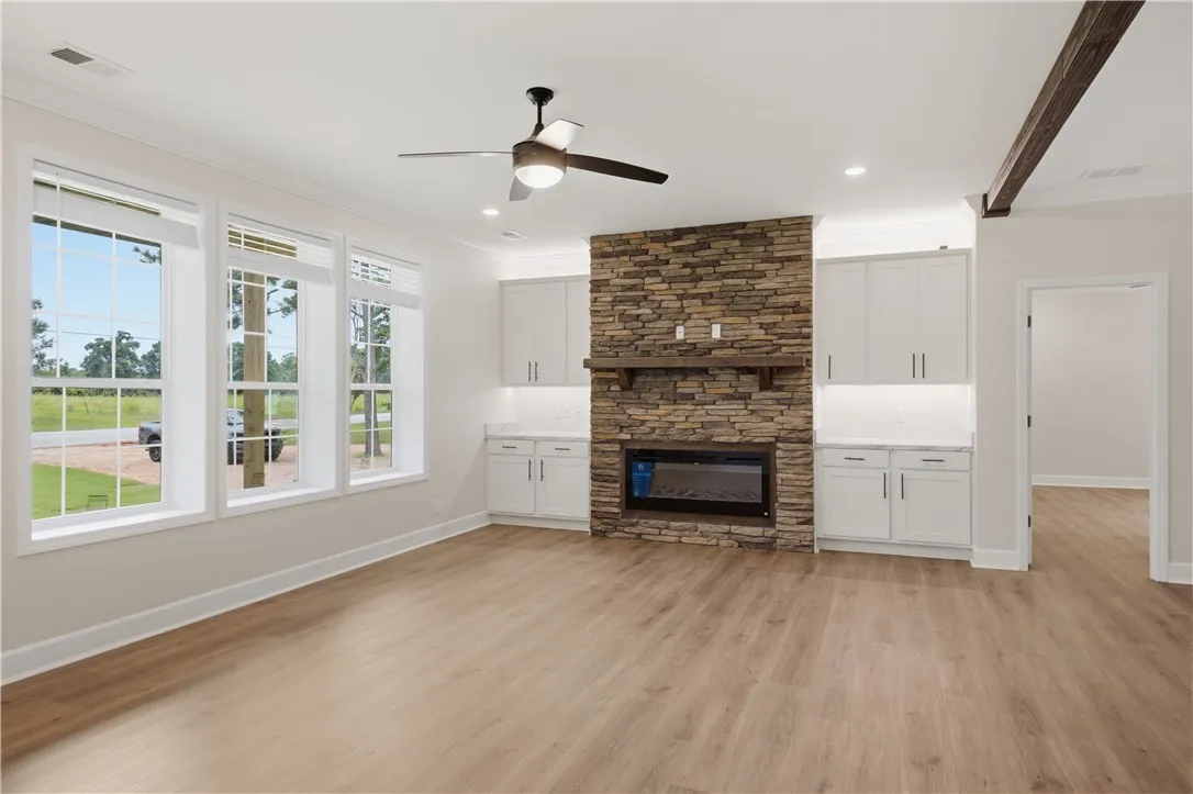 A striking stone fireplace anchors this living space, offering warmth and a visual focal point.