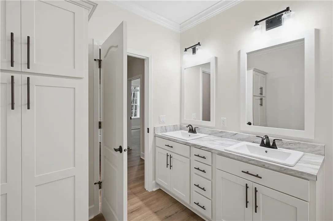 Dual vanity with pristine marble counters and ample storage, creating a functional, elegant space.