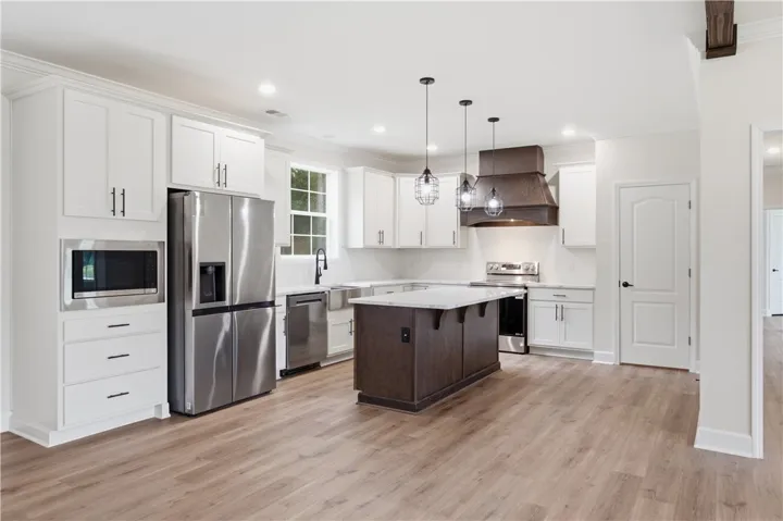 Culinary aspirations come alive in this well-appointed kitchen, boasting a functional island and gleaming stainless appliances.