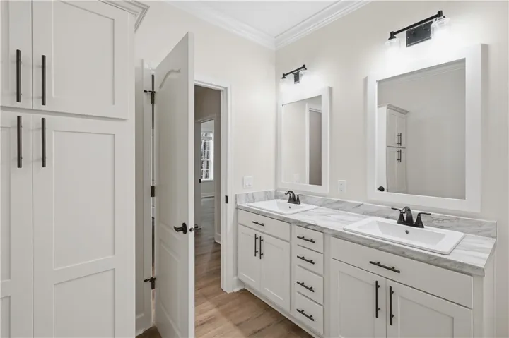 Dual vanity with pristine marble counters and ample storage, creating a functional, elegant space.