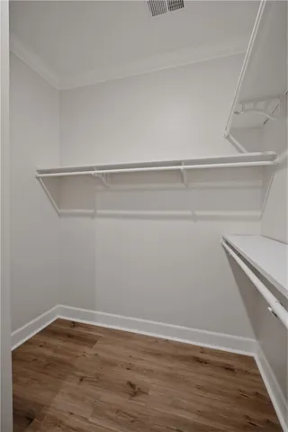 Ample shelving and hanging space in this well-appointed closet, ready for organization.