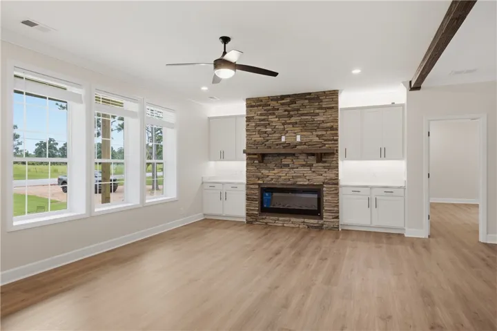A striking stone fireplace anchors this living space, offering warmth and a visual focal point.