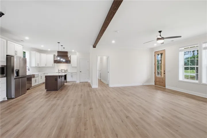 An open concept living area seamlessly connects to a contemporary kitchen, perfect for entertaining.