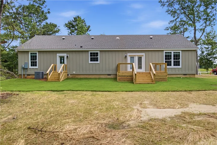 A well-maintained facade with freshly planted sod and dual entry points awaits new homeowners.